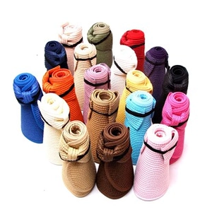 Multi-color roll-up straw visors arranged in a heart shape for travel sun protection