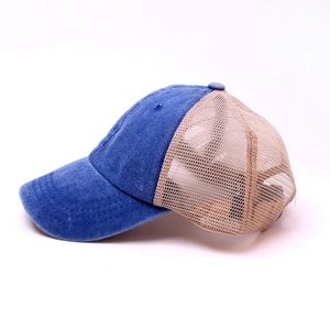 Detail of blue denim and beige mesh trucker hat with vintage washed finish and curved brim