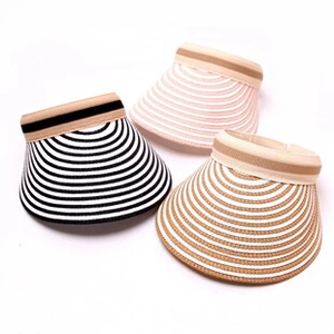 Detailed top view of three striped straw sun visors in black, pink and brown woven patterns