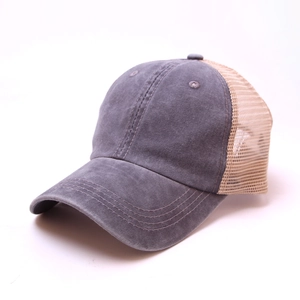 Detail view of the breathable beige mesh and washed grey cotton fabric on the baseball cap