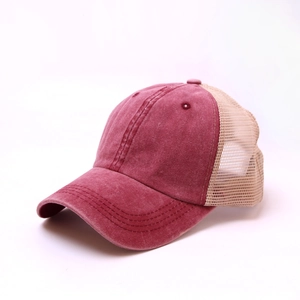 Detail view of burgundy washed cotton trucker hat with breathable mesh back panels