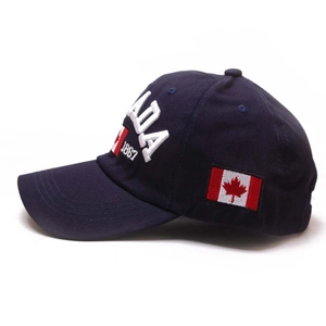 Detail of navy blue baseball cap featuring Canada 1867 embroidery and flag patch