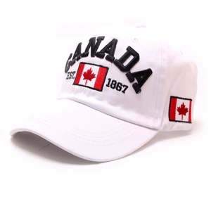 Close-up of black Canada embroidery and national flag patch on a white cotton baseball cap