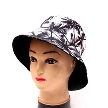 Detail of reversible bucket hat with black and white palm tree print and solid black lining