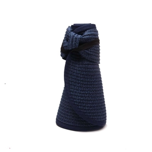 Navy blue foldable straw sun hat rolled up with black elastic strap for easy storage