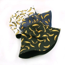 Three fruit pattern bucket hats in black, blue, and white with yellow banana print