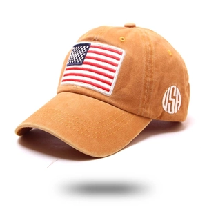 Detail of vintage washed mustard yellow baseball cap with American flag and USA embroidery