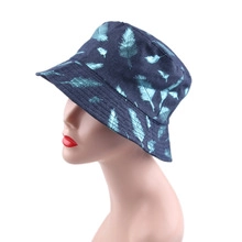 Detail of navy blue bucket hat featuring light blue feather pattern and reinforced stitching