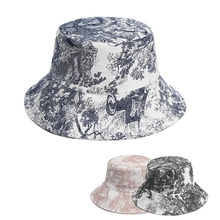 Three leopard print bucket hats in blue, pink, and gray toile de jouy canvas texture
