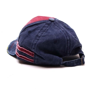 Detail view of washed denim baseball cap with vintage frayed edges and adjustable buckle strap