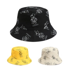 Detailed view of tie-dye bucket hats in black, yellow, and beige with cartoon prints