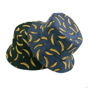 Reversible bucket hat with yellow banana pattern in black and dark blue canvas