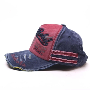Detailed macro view of 3D Rebel embroidery and vintage distressed cotton baseball cap texture