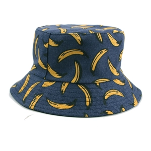 Detail view of double-sided reversible bucket hat with yellow banana pattern on navy blue fabric