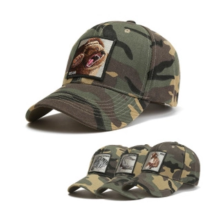 Detail of camouflage baseball caps featuring various animal embroidery patches like bear and zebra