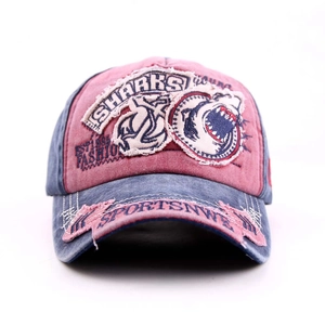 Detail of distressed embroidery on washed cotton baseball cap with shark pattern