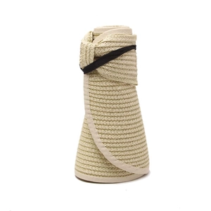 Detail of rollable straw sun hat with elastic strap for portable storage and travel