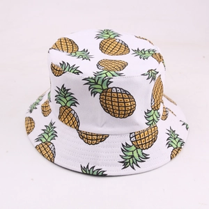 White reversible canvas bucket hat with yellow pineapple print for summer sun protection