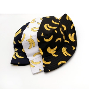 Detailed view of reversible cotton bucket hats with yellow banana patterns in blue, black, and white