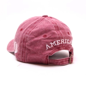 Detail of burgundy vintage washed cotton cap featuring white America embroidery and strap