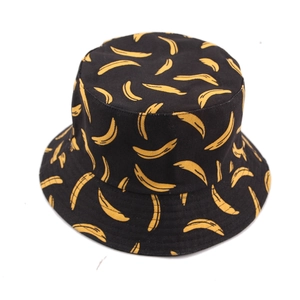 Reversible bucket hat featuring vibrant yellow banana patterns on a black canvas base