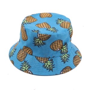 Bright blue reversible cotton bucket hat with yellow pineapple print for summer sun protection