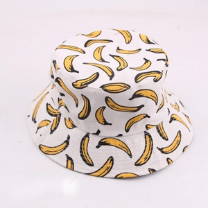 Reversible bucket hat with yellow banana pattern on white cotton canvas for sun protection