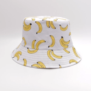White reversible bucket hat with yellow banana pattern for sun protection and travel