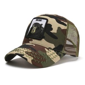 Close-up of camo trucker hat featuring a black bear patch and green breathable mesh