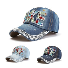Detail of denim baseball hats with sparkling rhinestone NIKE logo and crystal brim accents