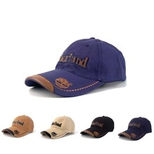 Detail of cotton baseball cap featuring leather brim piping and embroidered brand logo