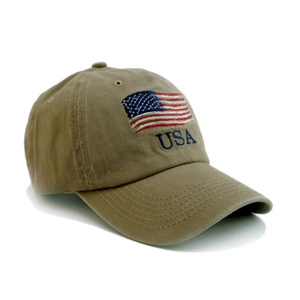 Detailed embroidery of the US flag and blue USA lettering on a khaki washed cotton baseball cap
