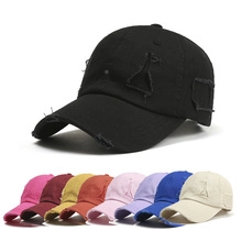 Detail of distressed cotton baseball cap showcasing multiple colors and vintage torn fabric