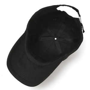 Internal view of black cotton baseball cap showing six-panel structure and metal buckle