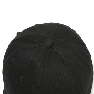 Detail view of black cotton baseball cap showing top button and embroidered eyelets