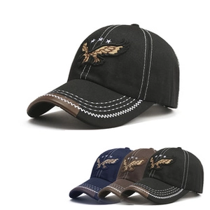 Detailed view of eagle embroidery and contrast stitching on vintage baseball caps in three colors