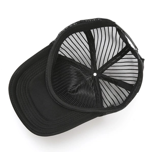 Detail view of adjustable plastic snapback and internal mesh stitching on black trucker hat