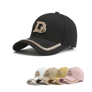 Detailed close-up showing rhinestone-trimmed brims and metal logo on baseball caps