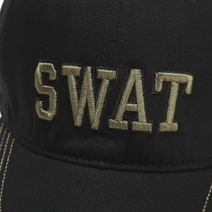 Detailed close-up of khaki SWAT embroidery on a black cotton tactical baseball cap