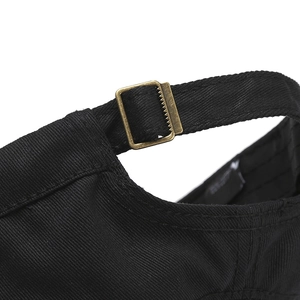 Détail de la casquette de baseball noire montrant la boucle réglable en bronze antique
