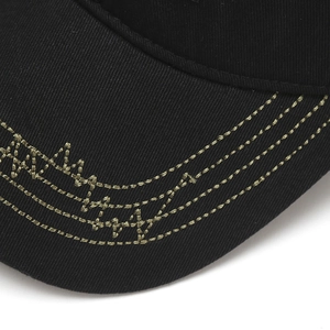 Detail of black cotton baseball cap brim with olive green embroidery and contrast stitching