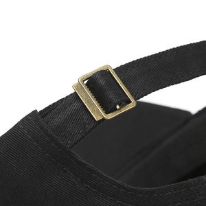 Detail of adjustable antique bronze metal buckle on black cotton camouflage baseball cap