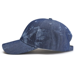 Side view detail of tie-dye pattern on navy blue denim baseball cap for sun protection