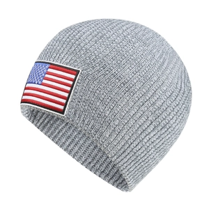 Grey knit beanie featuring an embroidered American flag patch for winter outdoor sports
