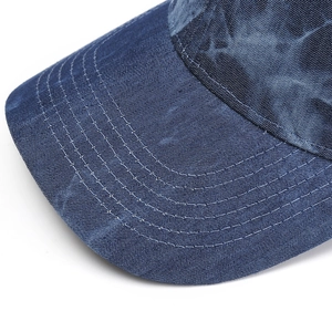 Close-up of blue denim baseball cap brim with five-row precision stitching detail