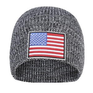 Detailed knit texture and embroidered American flag patch on a warm winter beanie