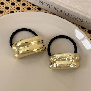 Set of two gold geometric metal hair ties with polished and hammered texture finishes