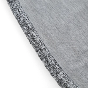 Detailed view of grey knitted beanie fabric with premium ribbed edge and dense stitching