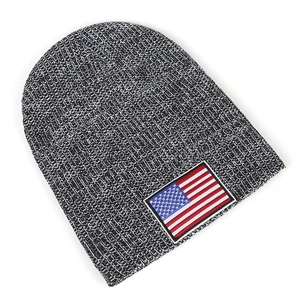 Close-up of knit beanie featuring salt and pepper texture and US flag embroidery patch