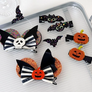 Detail of Halloween hair clips set with pumpkin, bat, and skull bow hair accessories